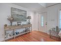 Inviting foyer featuring hardwood floors, elegant trim, and a stylish console table beneath a decorative art piece at 2410 Trent St, Charleston, SC 29414