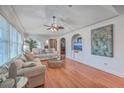 Bright living room with hardwood floors, crown molding, and a cozy seating arrangement with natural light at 2410 Trent St, Charleston, SC 29414