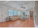 Spacious living room featuring hardwood floors, large windows, and comfortable seating, perfect for relaxation at 2410 Trent St, Charleston, SC 29414