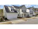 Attractive exterior featuring a two-car garage, lush landscaping, and a well-maintained yard in a residential neighborhood at 2425 Giles Ln, Mount Pleasant, SC 29466