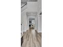 Bright hallway featuring beautiful wood flooring, staircase and modern white trim with views to the bright living room at 2425 Giles Ln, Mount Pleasant, SC 29466