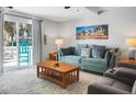 Inviting living room boasts plush seating, a decorative rug, and a sliding glass door with access to the balcony at 278 Driftwood Ln, Edisto Island, SC 29438