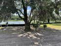 View of a pond surrounded by lush trees from a tree shaded lot at 2988 Lodge Berry Ln, Johns Island, SC 29455