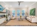 Cozy living room boasts a fireplace, built-in cabinets, and comfortable seating with natural light from large windows at 3092 Emma Ln, Mount Pleasant, SC 29466