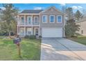 Charming two-story home with a front porch, a second story balcony and a large driveway at 339 Cicadas Song, Moncks Corner, SC 29461