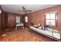 Bedroom with wood paneling, ceiling fan, windows and assorted furniture at 355 Nassau St, Charleston, SC 29403