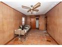 Bedroom with wood paneling, ceiling fan, windows, closet and assorted furniture at 355 Nassau St, Charleston, SC 29403