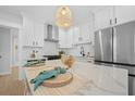 Modern kitchen featuring stainless steel appliances, a large marble countertop island, and ample white cabinetry at 42 Kennedy St, Charleston, SC 29403