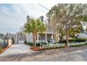 Classic two-story house with a front porch, dormer windows, a detached garage, and a tidy front lawn at 425 Mccants Dr, Mount Pleasant, SC 29464