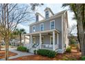 Beautiful two-story home with a charming front porch, dormer windows, and a professionally landscaped yard at 425 Mccants Dr, Mount Pleasant, SC 29464