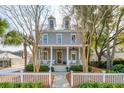 Inviting two-story home featuring dormer windows, a cozy front porch, and a well-manicured front yard at 425 Mccants Dr, Mount Pleasant, SC 29464
