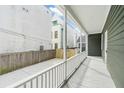 Inviting covered back porch with white railing overlooking a well maintained backyard and fence at 5 Maranda Holmes St, Charleston, SC 29403