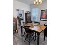 Cozy dining area with hardwood table, stylish chairs, and natural light from the window at 618 Hilchot Dr, Summerville, SC 29486