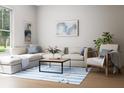 Cozy living room with a large window, comfortable sectional sofa and blue striped rug at 7626 Indigo Palms Way, Johns Island, SC 29455