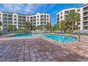 Large, inviting community pool with brick patio and plenty of lounge chairs for residents at 8000 Palmetto Dr # 506, Isle of Palms, SC 29451