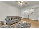 Inviting living room boasts hardwood floors, neutral walls, and a staircase at 9009 Cat Tail Pond Rd, Summerville, SC 29485