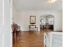Elegant foyer featuring hardwood floors, classic trim, with views into the living room and dining room at 105 S Palmetto St, Summerville, SC 29483