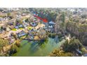 Aerial view of house and the community showing landscaping, neighboring houses and pond in the neighborhood at 1253 Lakefront Dr, Charleston, SC 29412