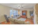 Cozy living room features hardwood floors, a ceiling fan, and access to the staircase at 128 Hornby Cir, Goose Creek, SC 29445
