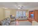 Comfortable living room with hardwood floors, a ceiling fan, and plenty of seating at 128 Hornby Cir, Goose Creek, SC 29445
