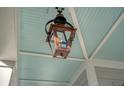 Gas lantern on the porch featuring copper and iron work with a baby-blue painted porch ceiling at 142 Midtown Ave, Summerville, SC 29486