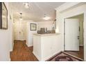 Inviting entryway featuring hardwood floors and a view of the kitchen area at 1622 Telfair Way, Charleston, SC 29412