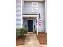 Inviting townhouse entrance featuring a dark door, potted plants, and American flag at 1662 Hunters Run Dr, Mount Pleasant, SC 29464