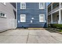Concrete parking area beside a blue two-story house with white trim and a walkway at 167 Spring St # A/B, Charleston, SC 29403