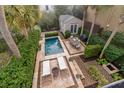 Aerial view of private backyard oasis with pool, lounging area, and lush landscaping at 18 Logan St, Charleston, SC 29401