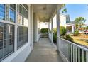 Inviting front porch offers a relaxing outdoor space with white railings and a ceiling fan at 2176 Andover Way, Mount Pleasant, SC 29466