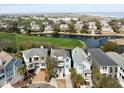 Aerial view of waterfront homes with scenic views of the golf course and the marsh at 27 Ocean Point Dr, Isle of Palms, SC 29451