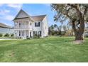 Home exterior showing the side, backyard, and a large shade tree at 3213 Great Egret Dr, Johns Island, SC 29455