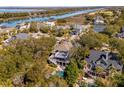 Breathtaking aerial view of a home with a pool and a scenic backdrop featuring a river and waterfront at 7 Seahorse Ct, Isle of Palms, SC 29451