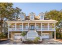 Stately home with a grand staircase, welcoming porch, and attached garages, perfect for Gathering living at 7 Seahorse Ct, Isle of Palms, SC 29451