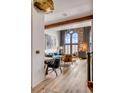 Open-concept living area featuring a large arched window, hardwood floors, and stylish decor at 71 Wentworth St # 302, Charleston, SC 29401