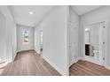 Bright hallway featuring wood floors, a front door, and access to a bathroom at 782 Blueway Ave, Summerville, SC 29486