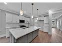 Modern kitchen with white cabinets, quartz countertops, stainless steel appliances, and island at 782 Blueway Ave, Summerville, SC 29486