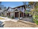 Charming townhome with a covered front entrance, lush landscaping, and wood siding at 8409 Hidden Bakers Trce, North Charleston, SC 29418