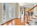 Welcoming foyer with hardwood floors, decorative front door, and staircase with wood railing at 8614 Arthur Hills Cir, North Charleston, SC 29420