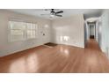 Bright living room with wood floors, a ceiling fan, and abundant natural light from large windows at 100 Pine Ridge Dr, Goose Creek, SC 29445
