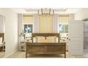 Spacious bedroom with a large window and decorative chandelier. The ensuite bathroom is conveniently accessible at 1029 Sagegrass St, Summerville, SC 29485