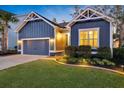 Home featuring a two-car garage, manicured lawn, and inviting entrance at 108 Whaler Ave, Summerville, SC 29486