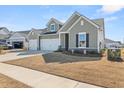 Charming two-story home with a three-car garage and well-manicured lawn at 1107 Bellwether Ln, Summerville, SC 29485