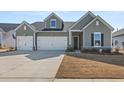 Charming two-story home with a three-car garage and well-manicured lawn at 1107 Bellwether Ln, Summerville, SC 29485