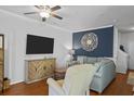 Inviting living room featuring hardwood floors, a modern TV, stylish decor, and comfortable seating arrangement at 130 River Landing Dr # 4209, Charleston, SC 29492