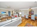 Open-concept living area with hardwood floors, comfortable seating, and a seamless flow between living and dining spaces at 1581 Cambridge Lakes Dr, Mount Pleasant, SC 29464