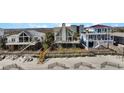 Beachfront house with deck access to the shore; an ideal coastal retreat with stunning ocean views and outdoor living at 1615 E Ashley Ave, Folly Beach, SC 29439