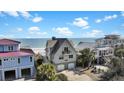 Charming beach house with double garage and balcony provides stunning ocean views, blending coastal elegance and functionality at 1615 E Ashley Ave, Folly Beach, SC 29439