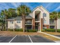Attractive condo building with palm trees, a parking lot, and well-kept greenery at 2011 N Highway 17 # 1400H, Mount Pleasant, SC 29466