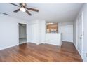 Bright living room featuring hardwood floors, a ceiling fan, and an open view to the kitchen at 2011 N Highway 17 # 1400H, Mount Pleasant, SC 29466